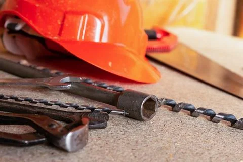 Set construction tools drill wrench saw helmet orange closeup Stock Photos