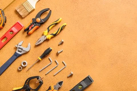 Set of construction tools on orange grunge background Stock Photos