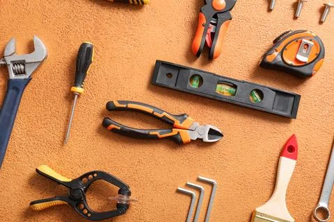 Set of construction tools on orange grunge background Stock Photos