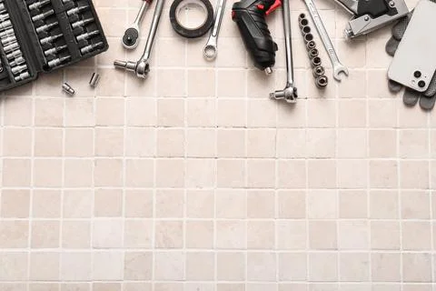 Set of construction tools on white tiled background Stock Photos