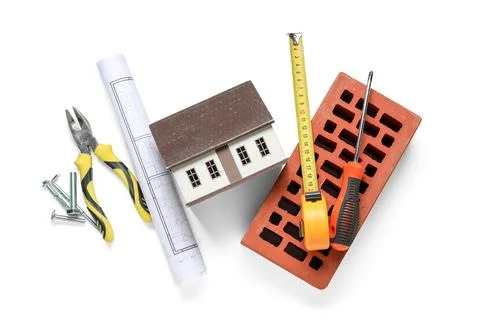 Set of construction workers tools with house model and brick on white backgro Stock Photos