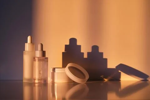 A set of cosmetics in the rays of the setting sun. Stock Photos