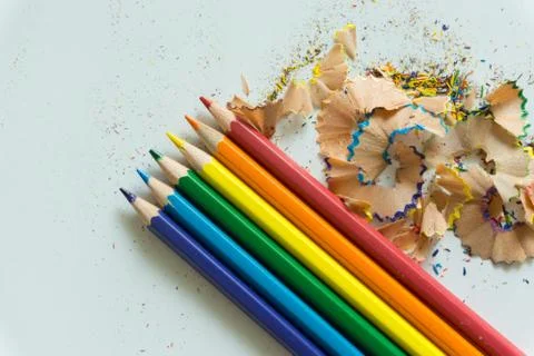 A set of crayons and sharpener on white background Stock Photos
