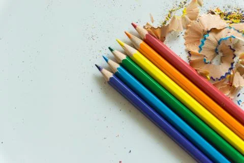A set of crayons and sharpener on white background Stock Photos