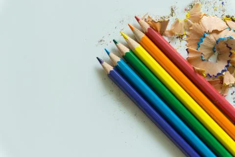 A set of crayons and sharpener on white background Stock Photos