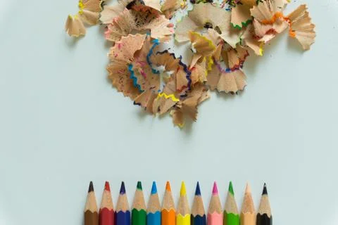 A set of crayons and sharpener on white background Stock Photos