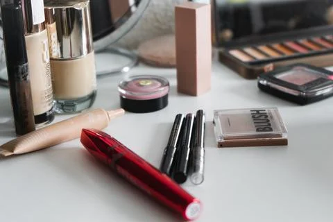 A set for creating makeup, randomly laid out on a white table; shadows, masca Stock Photos