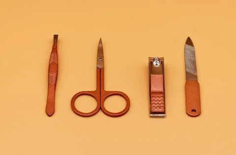 Set for cutting nails. Tools of a manicure set on a beige background Stock Photos
