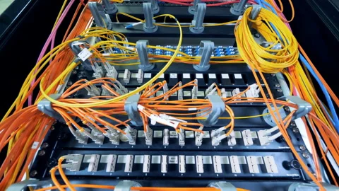 Set of data servers linked by multicolour wires 스톡 동영상 99679328