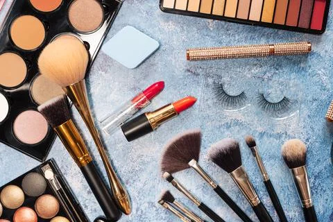 Set of decorative cosmetics, makeup brushes on a blue background. the view from Stock Photos