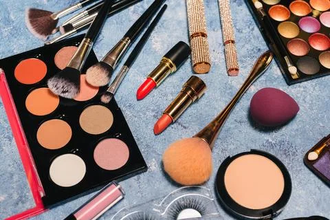 Set of decorative cosmetics, makeup brushes false eyelashes on a blue background Stock Photos