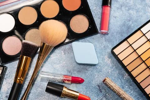 Set of decorative cosmetics, makeup brushes on a blue background. the view from Stock Photos
