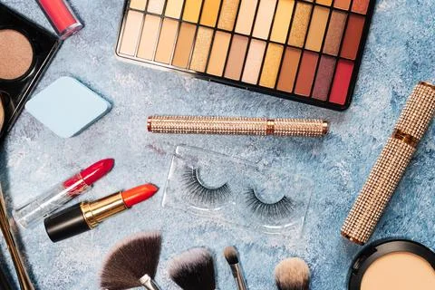 Set of decorative cosmetics, makeup brushes on a blue background. the view from Stock Photos