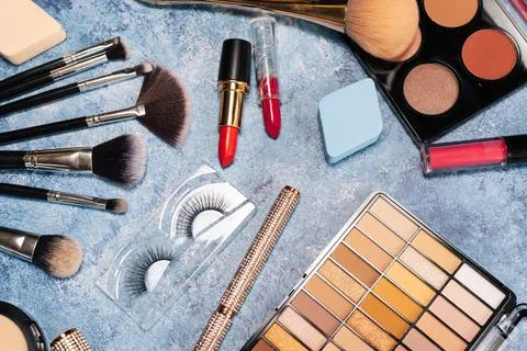 Set of decorative cosmetics, makeup brushes on a blue background. the view from Stock Photos