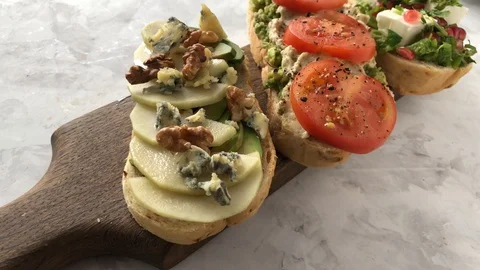 Set of delicious bruschetta on a cutting Board Stock Footage 129179953