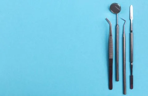 Set of dental instruments on a blue background Stock Photos