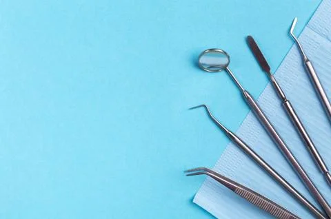 Set of dental instruments on a blue background 库存照片