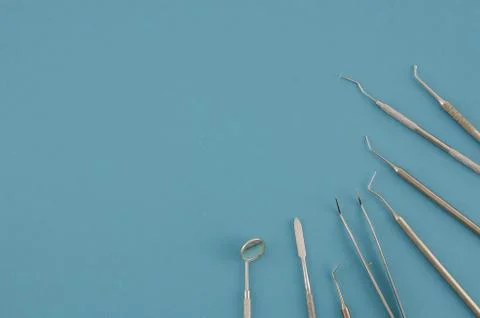 Set of dentist tools on blue background.Flat lay top view stomatologist mock up Stock Photos