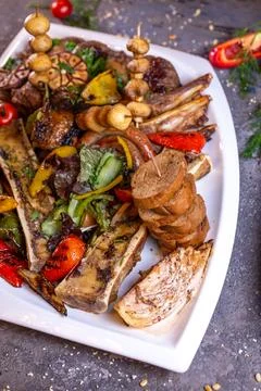 A set of different beef meat dishes on a white plate Stock Photos