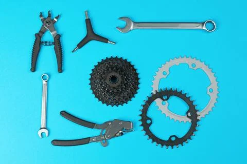 Set of different bicycle tools and parts on color background, flat lay Stock Photos