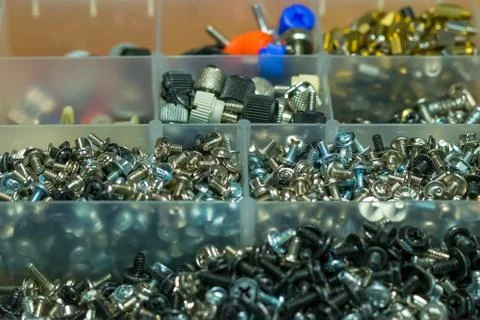 A set of different bolts, nuts for a computer in a box, sorted by cells Stock Photos