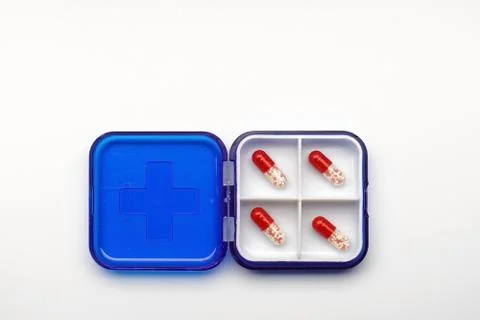 Set of different capsules and tablets in a box for daily dosage. Hospital first Stock Photos