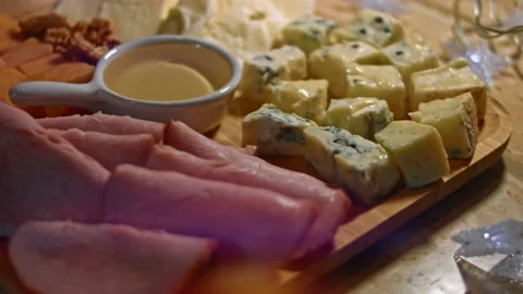 Set of different cheeses, pork ham, honey and greek nuts on a wooden tray Stock Footage 146475019