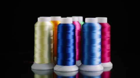 Set of different color sewing threads,on black background. Stock Footage 246716054