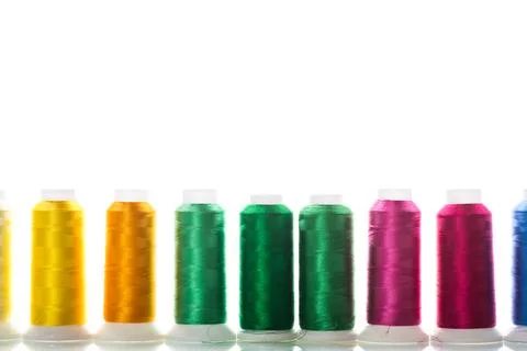 Set of different color sewing threads,on white background. Stock Photos