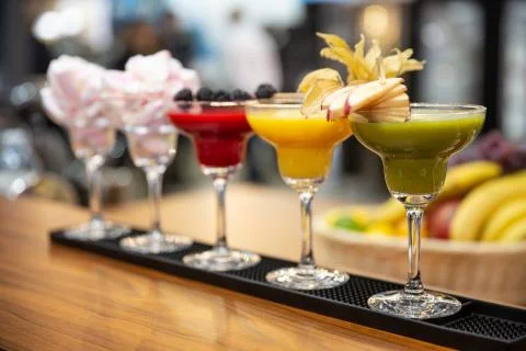 A set of different colored smoothies in glasses on wooden background. healthy Stock Photos