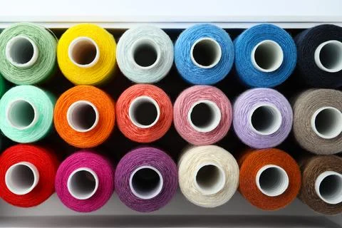 Set of different colorful sewing threads in container on white background, .. Stock Photos