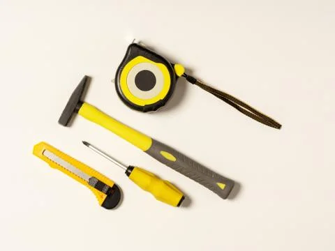 Set of different construction tools on white background. Knife, tape measure, Stock Photos