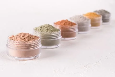 Set of different cosmetic clay mud powders on white background Stock Photos