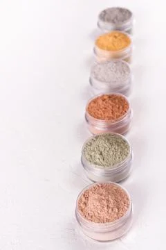 Set of different cosmetic clay mud powders on white background Stock Photos