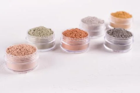 Set of different cosmetic clay mud powders on white background Stock Photos