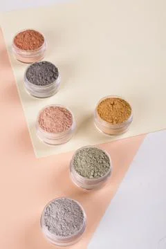 Set of different cosmetic clay mud powders on white background Foto stock