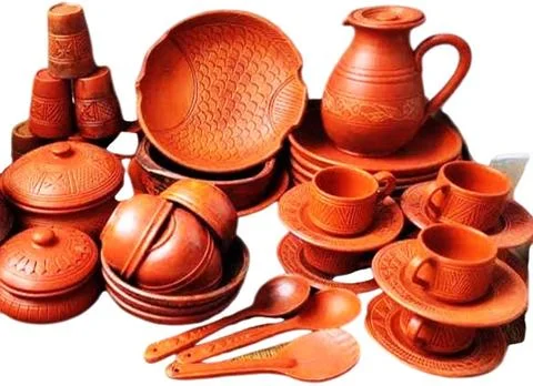 Set of different crafting tools and clay dishes. Stock Photos