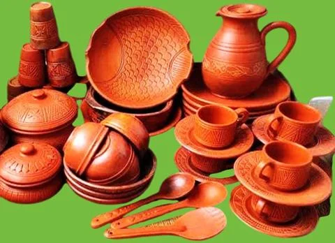 Set of different crafting tools and clay dishes. Stock Photos