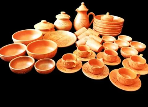 Set of different crafting tools and clay dishes. Stock Photos