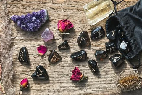 Set of different crystals and rune stones on wood Stock Photos