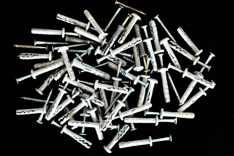Set of different dowels isolated on dark background. Close-up Stock Photos