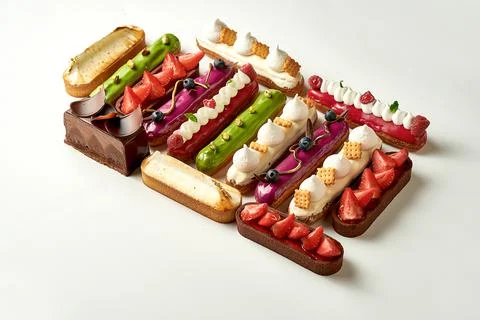 A set of different eclairs with filling. Selective focus, close-up Stock Photos