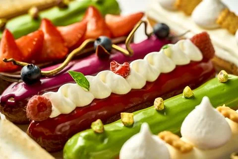 A set of different eclairs with filling. Selective focus, close-up Stock Photos