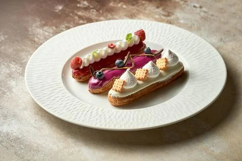 A set of different eclairs with filling. Selective focus, close-up Stock Photos