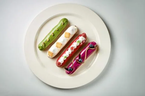 A set of different eclairs with filling. Selective focus, close-up Stock Photos