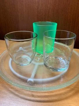 Set of Different Empty Drinking Glasses on Glass Tray Stock Photos