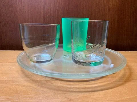 Set of Different Empty Drinking Glasses on Glass Tray Stock Photos