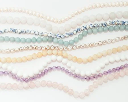 Set of different gemstones beads in light colors Stock Photos