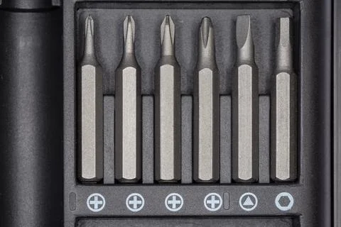 Set of different interchangeable bits for screwdriver in case, top view Stock Photos