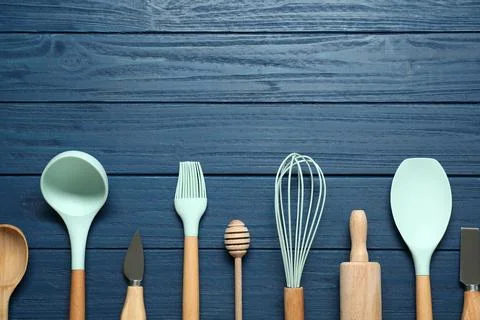 Set of different kitchen utensils on blue wooden table, flat lay. Space for.. Stock Photos